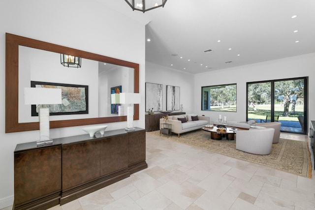 living room featuring an inviting chandelier and ornamental molding