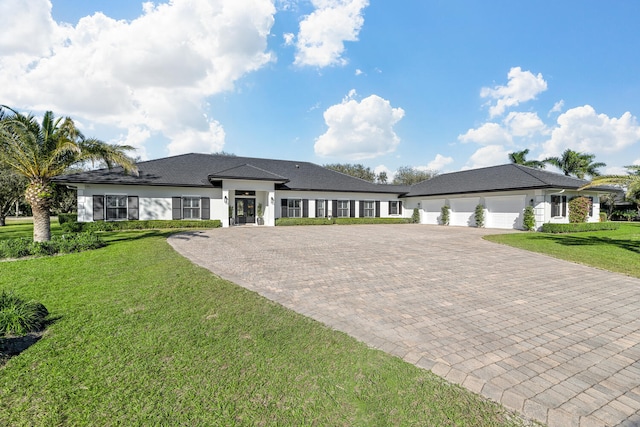 prairie-style house with a garage and a front lawn