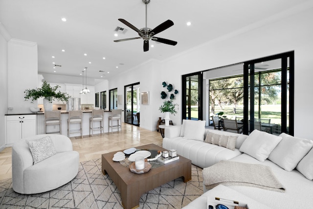 living room featuring ceiling fan and ornamental molding