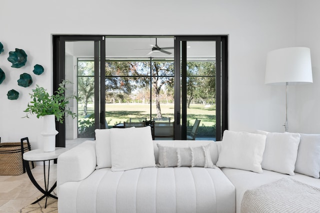 living room with a wealth of natural light and ceiling fan