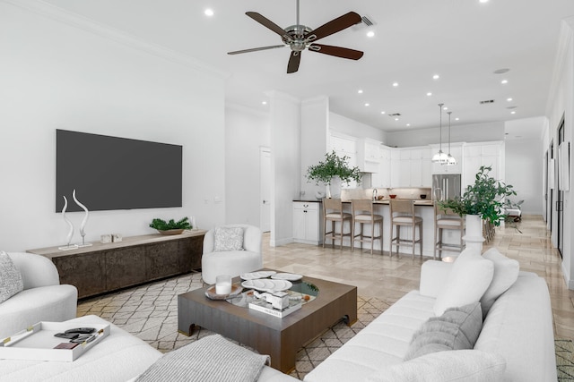 living room with ceiling fan and ornamental molding