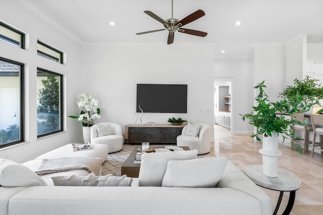 living room featuring ceiling fan and crown molding