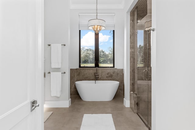 bathroom featuring concrete floors, ornamental molding, a notable chandelier, and plus walk in shower