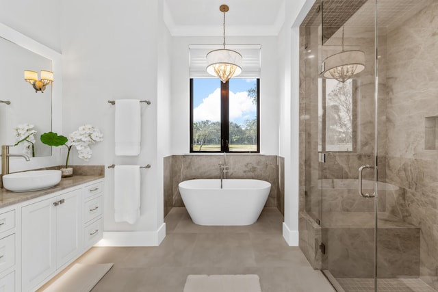 bathroom featuring a chandelier, vanity, and separate shower and tub