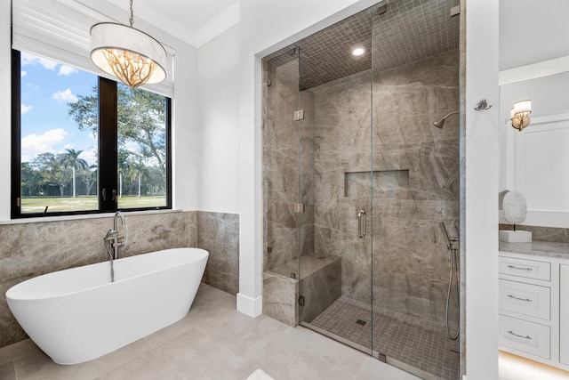 bathroom featuring tile patterned flooring, tile walls, a chandelier, and shower with separate bathtub