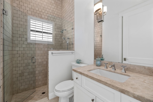 bathroom with toilet, a shower with door, and vanity