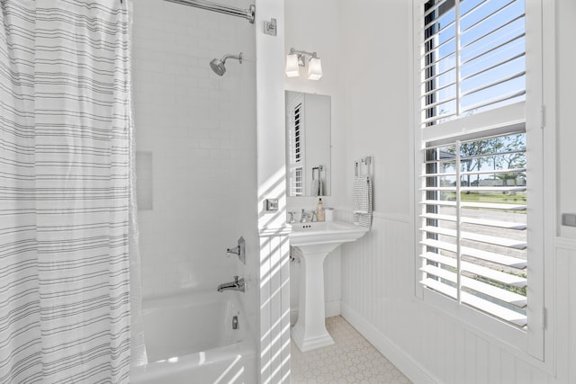 bathroom featuring sink, tile patterned floors, and shower / tub combo with curtain