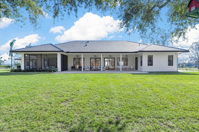 back of house with ceiling fan, a yard, and a patio