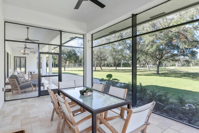 sunroom featuring ceiling fan