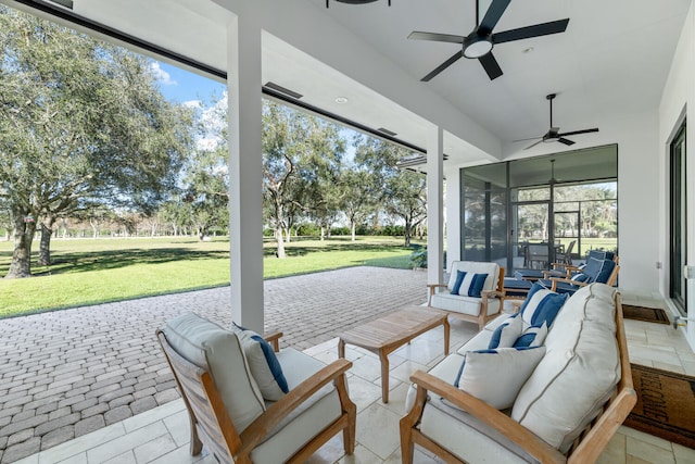 sunroom featuring ceiling fan