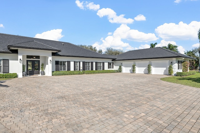 view of front of home with french doors and a garage