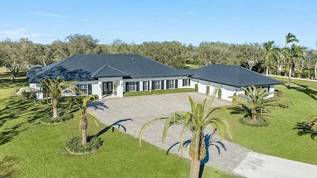 back of property featuring a lawn and a garage