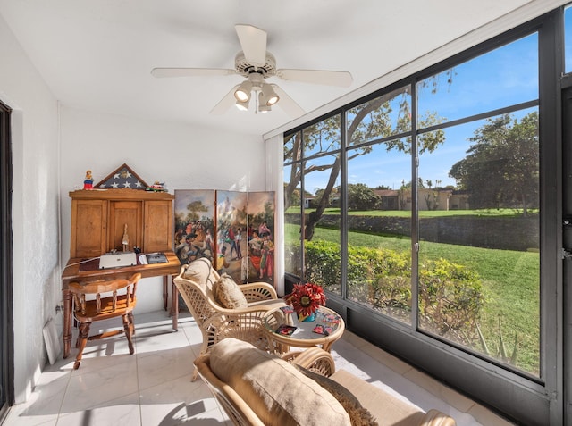 sunroom featuring ceiling fan