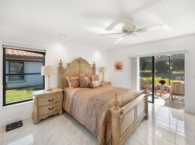 bedroom with ceiling fan and a textured ceiling