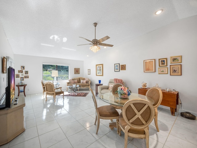 dining space with ceiling fan and a textured ceiling