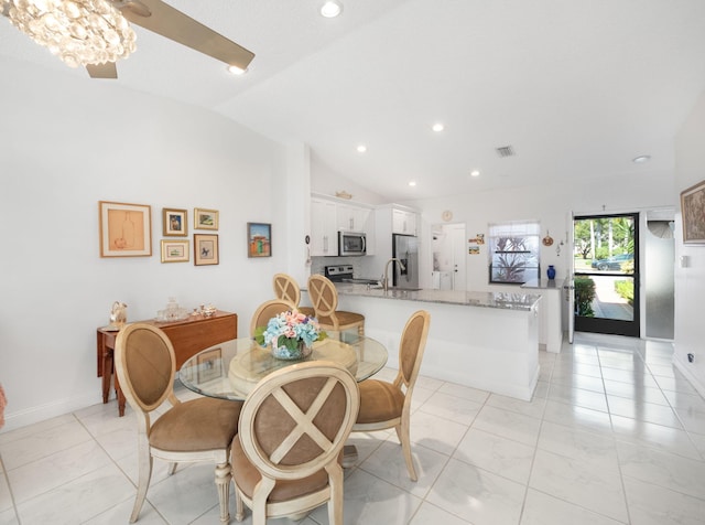 dining area with vaulted ceiling and sink