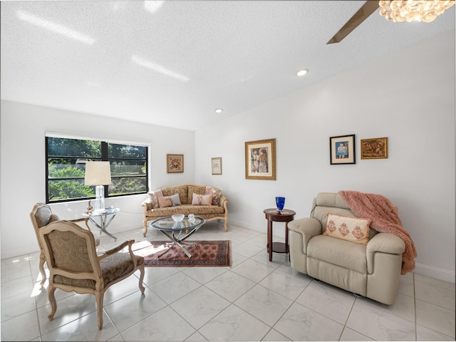 living room featuring ceiling fan, lofted ceiling, and a textured ceiling