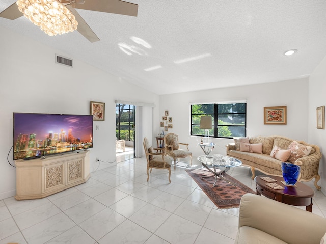 living room with lofted ceiling, a textured ceiling, and a chandelier