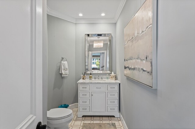 bathroom featuring tile patterned flooring, vanity, toilet, and crown molding