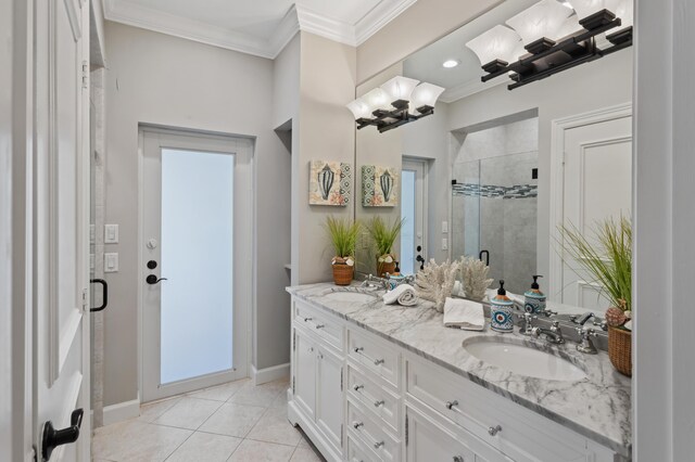 bathroom with tile patterned flooring, ornamental molding, vanity, and a shower with shower door