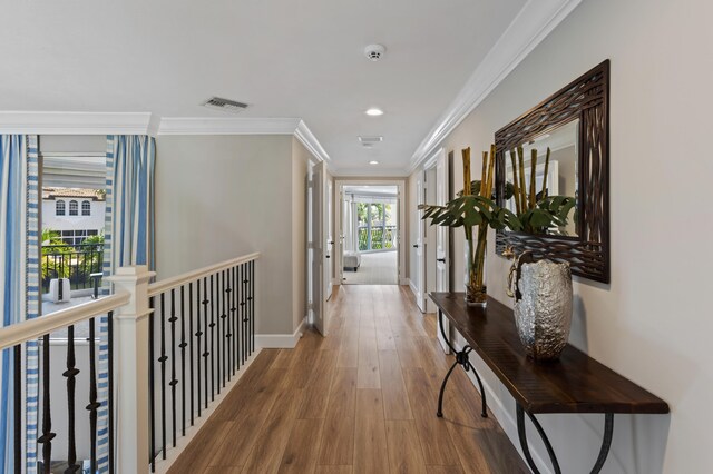 hall featuring hardwood / wood-style flooring and ornamental molding