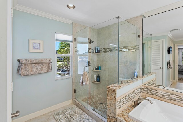 bathroom featuring tile patterned floors, sink, an enclosed shower, and crown molding