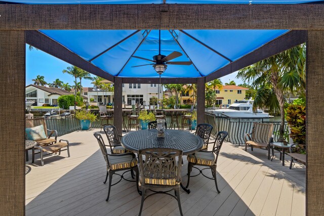 wooden terrace with a gazebo and ceiling fan