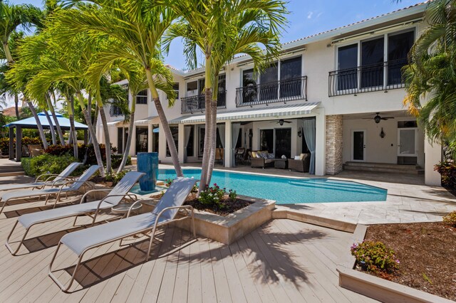 view of swimming pool featuring outdoor lounge area, ceiling fan, a patio area, and a deck