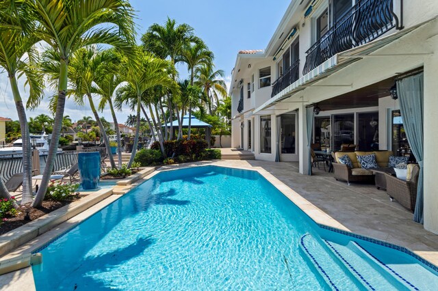 view of pool featuring outdoor lounge area, a gazebo, and a patio