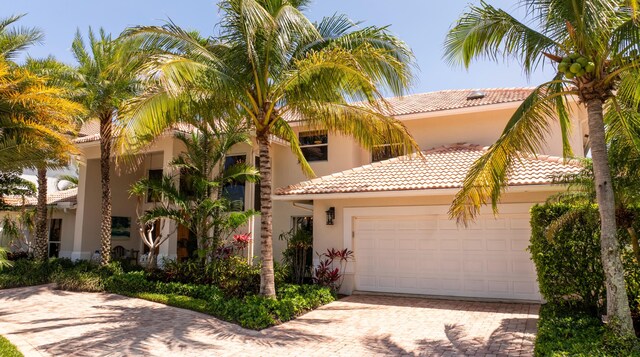 mediterranean / spanish house featuring a garage