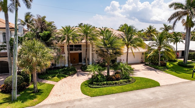 mediterranean / spanish-style home with a front yard