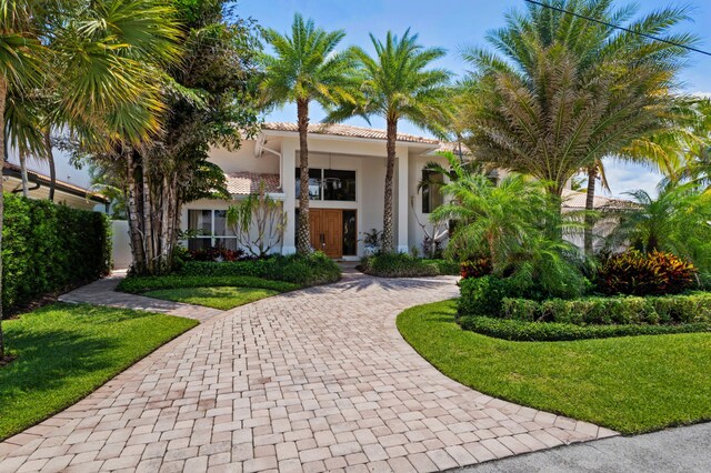 mediterranean / spanish home featuring a front yard