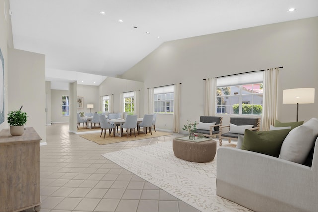 living room with light tile patterned floors and high vaulted ceiling