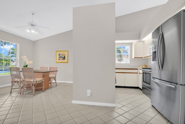 kitchen with ceiling fan, light tile patterned flooring, white cabinetry, and stainless steel appliances