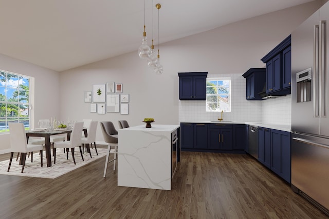 kitchen with backsplash, high end refrigerator, blue cabinets, vaulted ceiling, and a kitchen bar