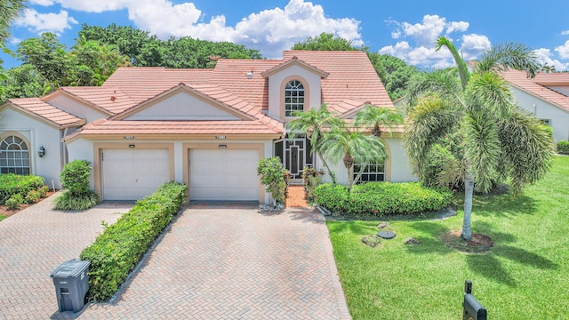 view of front of property featuring a front lawn and a garage