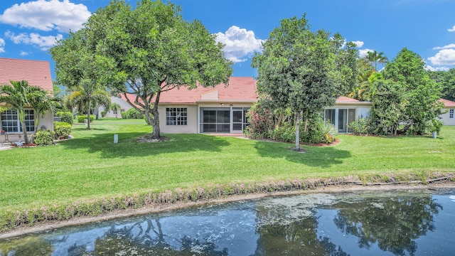 back of house featuring a lawn