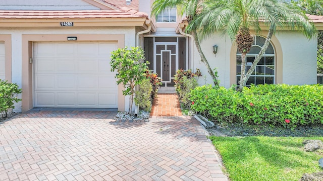 doorway to property with a garage