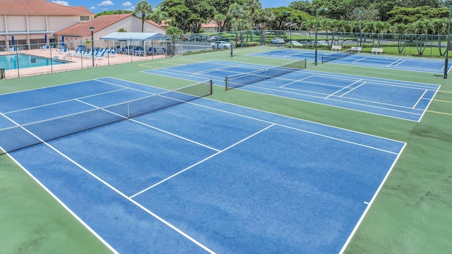 view of tennis court featuring basketball court