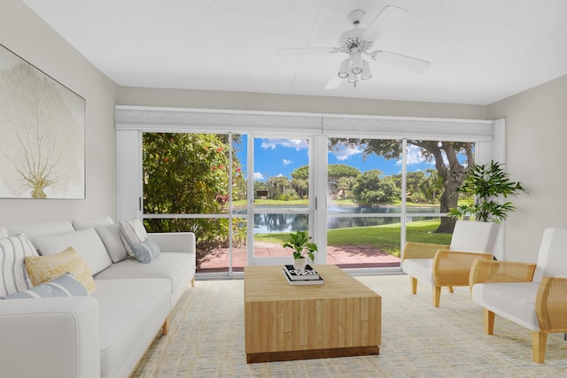 sunroom with a water view, ceiling fan, and a healthy amount of sunlight