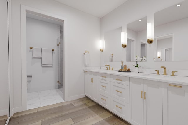 bathroom featuring vanity and an enclosed shower