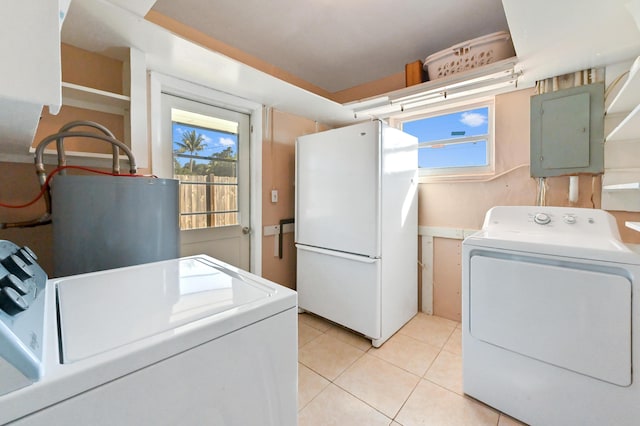 clothes washing area with water heater, independent washer and dryer, light tile patterned flooring, and electric panel