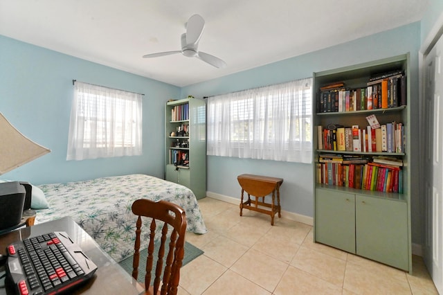 bedroom with ceiling fan and light tile patterned flooring