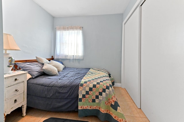 bedroom featuring a closet and light tile patterned floors