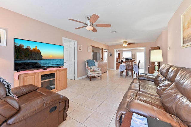 living room with ceiling fan and light tile patterned floors