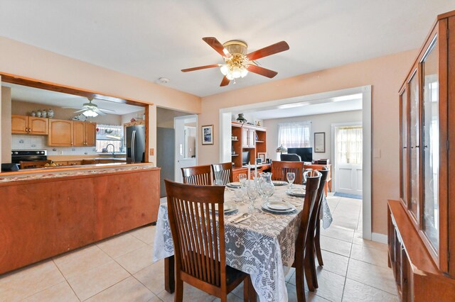 living room with ceiling fan and light tile patterned floors