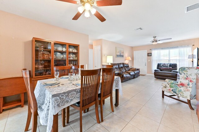 tiled living room with ceiling fan