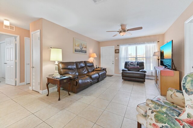 tiled dining space with ceiling fan