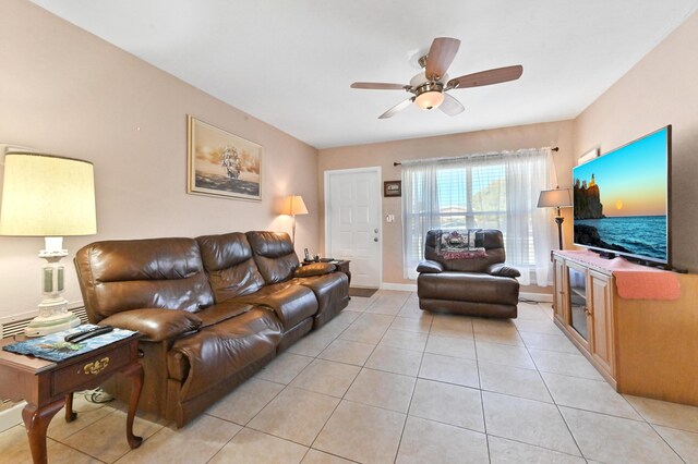 kitchen with stainless steel appliances, sink, ceiling fan, light tile patterned floors, and washer / dryer