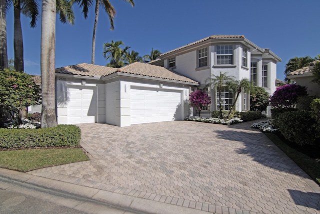 mediterranean / spanish house featuring a garage